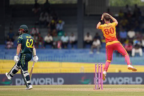 Zimbabwe's Bradley Evans, right, celebrates the wicket of Australia's captain Travis Head, left, during the T20 World Cup cricket match between Australia and Zimbabwe in Colombo, Sri Lanka.
