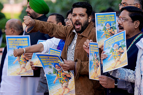 Congress MP Shafi Parambil and other party MPs protest holding placards during the Budget session of Parliament, in New Delhi.