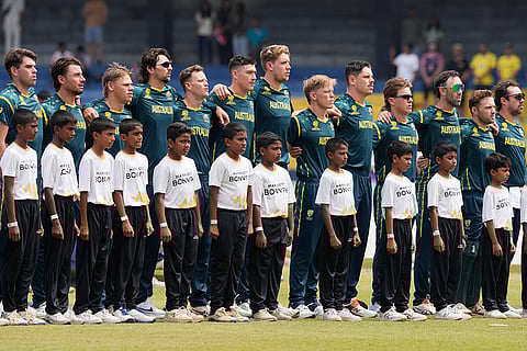 Australia's players stand up for the national anthems before the start of the during the T20 World Cup cricket match between Australia and Zimbabwe in Colombo, Sri Lanka.