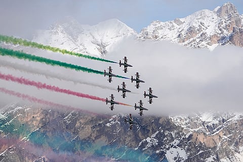 The Italian Frecce Tricolori acrobatic squad flies above during the medal ceremony of an alpine ski, women's super-G race, at the 2026 Winter Olympics, in Cortina d'Ampezzo, Italy.