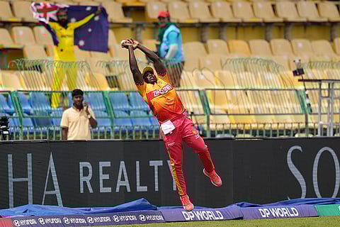 Zimbabwe's Tony Munyonga jumps to catch a ball during the T20 World Cup cricket match between Australia and Zimbabwe in Colombo, Sri Lanka.