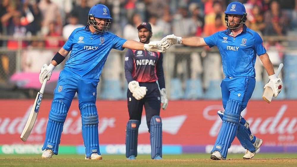 Italy's Justin Mosca, left, Anthony Mosca, right, encourage each other as they bat during the T20 World Cup cricket match between Italy and Nepal in Mumbai, India. - | Photo: AP/Rafiq Maqbool