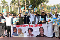 | Photo: Shahbaz Khan/PTI  : Congress MP Sukhjinder Singh Randhawa and other Opposition MPs stage a protest during the Budget session of Parliament, in New Delhi.