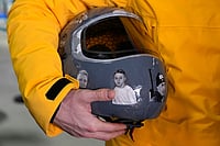 | Photo: AP/Alessandra Tarantino : Ukrainian skeleton athlete Vladyslav Heraskevych holds his crash helmet as he stands in the mixed zone of the sliding center at the 2026 Winter Olympics, in Cortina d'Ampezzo, Italy.