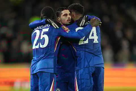 Chelsea's Moises Caicedo, left, and Reece James hug Pedro Neto after he scored during the English FA Cup fourth round soccer match between Hull City and Chelsea in Hull, England, Friday, Feb. 13, 2026.