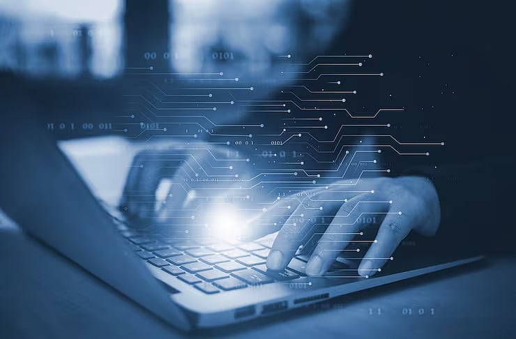 Glow-effect hands typing on a laptop with digital data lines overlay.