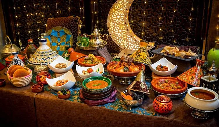 Lavish Ramadan Iftar buffet with traditional Arabic dishes and a glowing crescent moon decoration