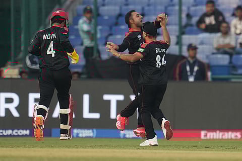 Canada's Saad Bin Zafar, second right, captain Dilpreet Bajwaduring and Shreyas Movva celebrates the wicket of United Arab Emirates' Aryansh Sharma the T20 World Cup cricket match between Canada and United Arab Emirates in New Delhi.