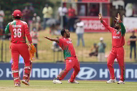 Oman's Shakeel Ahamed, centre, celebrates with teammates the wicket of Ireland's Harry Tector during the T20 World Cup cricket match between Ireland and Oman in Colombo, Sri Lanka.