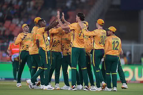 South Africa's Marco Jansen, centre, celebrates with teammates the wicket of New Zealand's Rachin Ravindra during the T20 World Cup cricket match between South Africa and New Zealand in Ahmedabad.