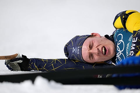 Sebastian Samuelsson, of Sweden, reacts in the finish area of the men's 10-kilometer sprint biathlon race at the 2026 Winter Olympics in Anterselva, Italy.