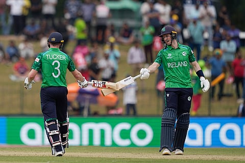 Ireland's Lorcan Tucker, left, George Dockrell, right, encourage each other as they bat during the T20 World Cup cricket match between Ireland and Oman in Colombo, Sri Lanka.