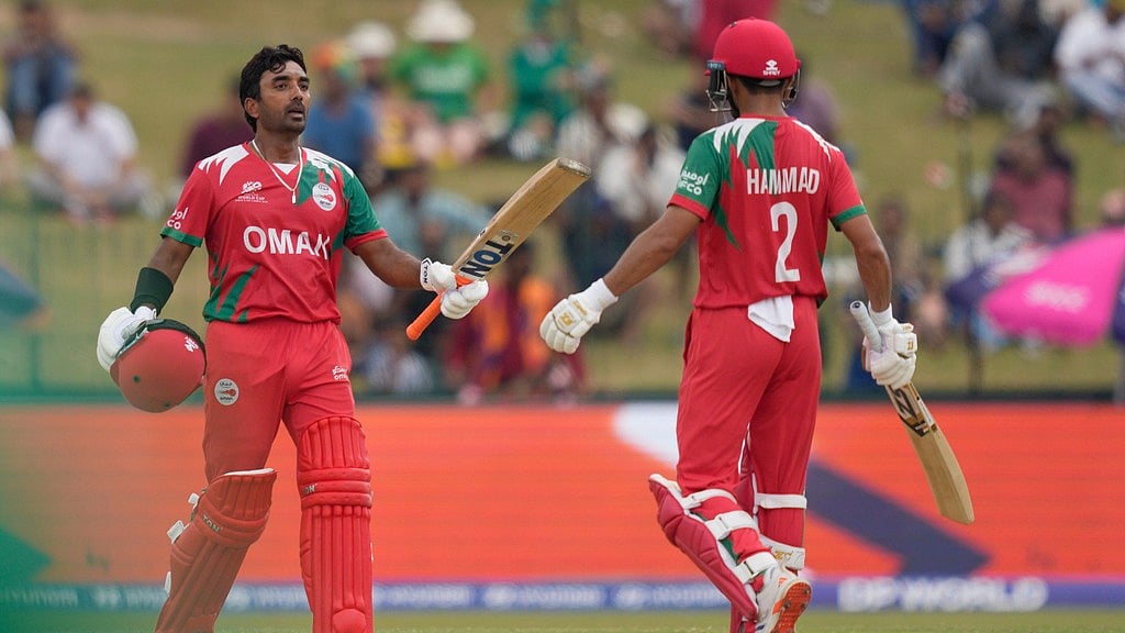 Oman's Syed Aamir Kaleem, left, celebrates his fifty runs with batting partner Hammad Mirza during the T20 World Cup cricket match between Ireland and Oman in Colombo, Sri Lanka, Saturday, Feb. 14, 2026.  - AP Photo/Eranga Jayawardena