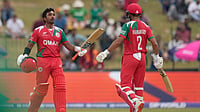 AP Photo/Eranga Jayawardena : Oman's Syed Aamir Kaleem, left, celebrates his fifty runs with batting partner Hammad Mirza during the T20 World Cup cricket match between Ireland and Oman in Colombo, Sri Lanka, Saturday, Feb. 14, 2026. 