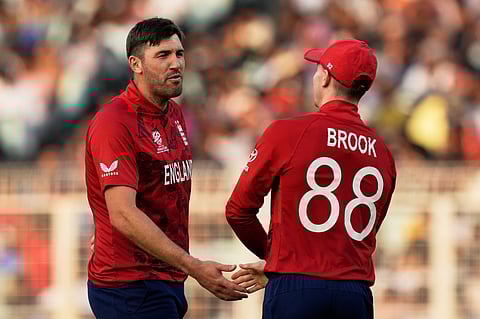 England's Jamie Overton and captain Harry Brook celebrate the wicket of Scotland's Bradley Wheal during the ICC T20 World Cup 2026 Group C cricket match between England and Scotland in Kolkata.