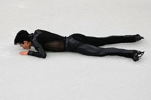 Donovan Carrillo of Mexico kisses the ice after competing during the men's free skate program in figure skating at the 2026 Winter Olympics, in Milan, Italy.