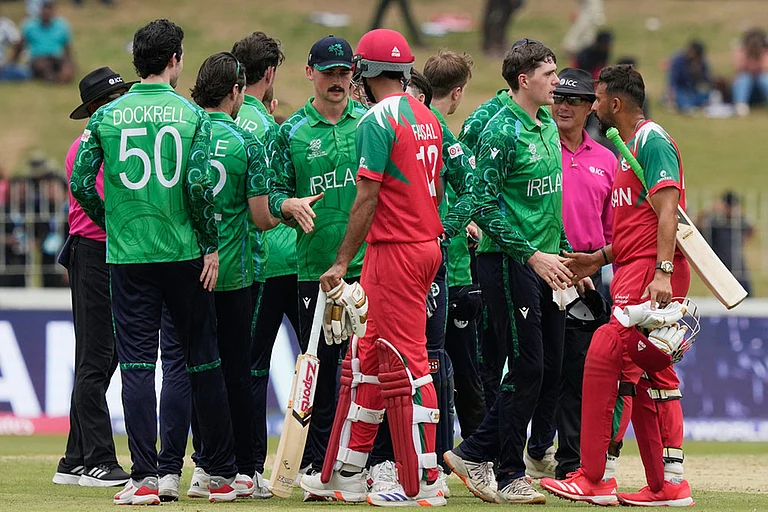 Ireland's players shake hands with Oman's players after they won the T20 World Cup cricket match against Oman in Colombo, Sri Lanka. - | Photo: AP/Eranga Jayawardena