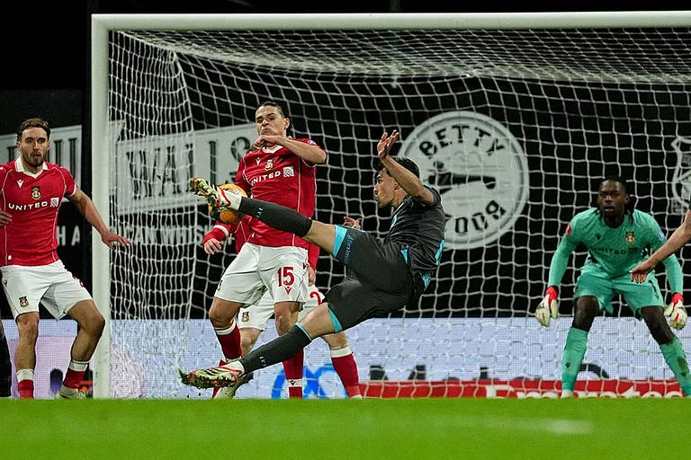 Ipswich Town's Jacob Greaves, front, has a shot at goal blocked by Wrexham's George Dobson (15) during an English FA Cup fourth round soccer in Wrexham, Wales. - | Photo: Martin Rickett/PA via AP