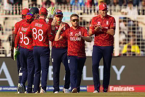 England's Liam Dawson, second right, celebrates with teammates the wicket of Scotland's Tom Bruce during the T20 World Cup cricket match between England and Scotland in Kolkata, India.