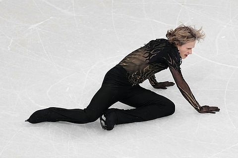Ilia Malinin of the United States falls during the men's free skate program in figure skating at the 2026 Winter Olympics, in Milan, Italy.