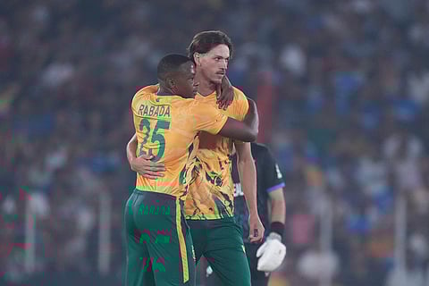 South Africa's Marco Jansen, right, and South Africa's Kagiso Rabada celebrates the wicket of New Zealand's Mark Chapman during the T20 World Cup cricket match between South Africa and New Zealand in Ahmedabad.