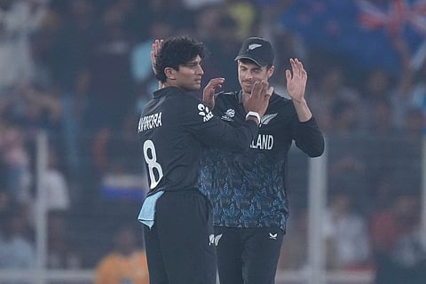 New Zealand's Rachin Ravindra, left, and New Zealand's captain Mitchel Santner celebrates the wicket of South Africa's Dewald Brevis during the T20 World Cup cricket match between South Africa and New Zealand in Ahmedabad.