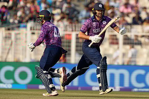 Scotland's captain Richie Berrington, left, and batting partner Tom Bruce run between the wickets during the T20 World Cup cricket match between England and Scotland in Kolkata, India.