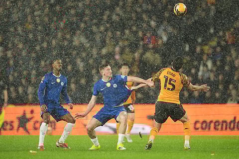 Hull City's John Egan holds Chelsea's Liam Delap during the English FA Cup fourth round soccer match between Hull City and Chelsea in Hull, England.