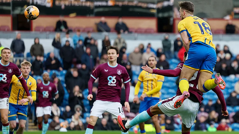 Mansfield Town's Rhys Oates, top, scores during the English FA Cup fourth round soccer match between Burnley and Mansfield Town in Burnley, England, Saturday Feb. 14, 2026. - | Photo: PA/Richard Sellers via AP