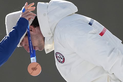 Sturla Holm Laegreid, of Norway, gets the bronze medal for the men's 10-kilometer sprint biathlon race at the 2026 Winter Olympics in Anterselva, Italy.