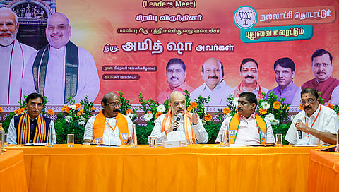 Union Home Minister Amit Shah during a meeting with BJP Puducherry state office bearers at the party headquarters during his campaign visit, in Puducherry. Union Minister Mansukh L. Mandaviya and others are also seen. 