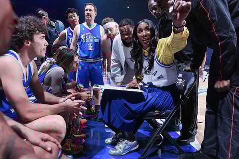 Former WNBA star Lisa Leslie, second from right, talks to players during an NBA basketball's All-Star Celebrity Game in Inglewood, Calif.