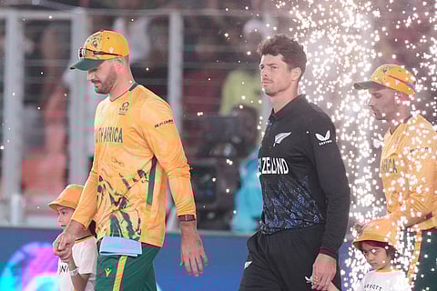 South Africa's captain Aiden Markram along with New Zealand's captain Mitchel Santner arrives with their team for the anthem before the start of the ICC T20 World Cup 2026 cricket match between South Africa and New Zealand in Ahmedabad.