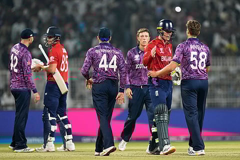 England's Will Jacks, second left, and batting partner Tom Banton, second right, shake hands with Scotland's Tom Bruce and Bradley Wheal respectively after England won the T20 World Cup cricket match against Scotland in Kolkata.