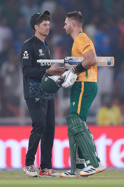 South Africa's captain Aiden Markram, right, shake hands with New Zealand's captain Mitchel Santner after his team won the the T20 World Cup cricket match against New Zealand in Ahmedabad.