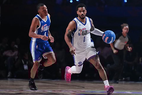Rome Flynn dribbles past Andre De Grasse during an NBA basketball's All-Star Celebrity Game Friday, Feb. 13, 2026, in Inglewood, Calif