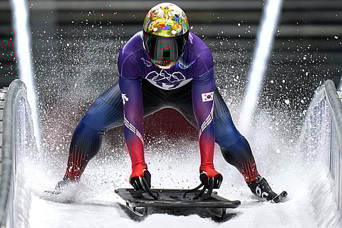 South Korea's Jisoo Kim arrives at the finish during a men's skeleton run at the 2026 Winter Olympics, in Cortina d'Ampezzo, Italy.