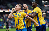 FA Cup 2025-26 Fourth Round: League One Mansfield Shock Burnley, Man City Progress | Photo: PA/Richard Sellers via AP : Mansfield Town's Louis Reed, left, celebrates scoring during the English FA Cup fourth round soccer match between Burnley and Mansfield Town in Burnley, England, Saturday Feb. 14, 2026.