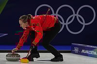 | Photo: AP/Fatima Shbair : Canada's Rachel Homan in action during the women's curling round robin session against Switzerland at the 2026 Winter Olympics, in Cortina d'Ampezzo, Italy.