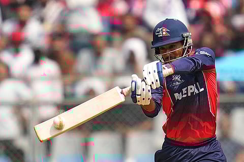 Nepal's Sompal Kami hits a boundary during the T20 World Cup cricket match between Nepal and West Indies in Mumbai.