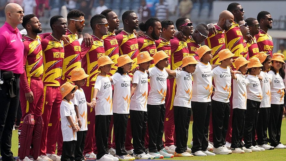 West Indies players stand up for the national anthems before the start of the match during the T20 World Cup cricket match between Nepal and West Indies in Mumbai. - | Photo: AP/Rafiq Maqbool