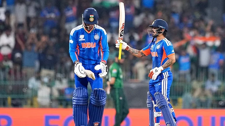 India's Ishan Kishan, right, celebrates his fifty runs as batting partner Tilak Varma looks on during the T20 World Cup cricket match between India and Pakistan in Colombo, Sri Lanka. - | Photo: AP/Eranga Jayawardena