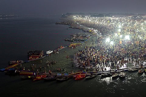 People take a holy dip at Sangam on the occasion of 'Maha Shivaratri', in Prayagraj.