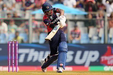 Nepal's Aasif Sheikh hits a boundary during the T20 World Cup cricket match between Nepal and West Indies in Mumbai.