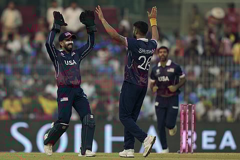 United States' Shubham Ranjane, right, celebrates with teammate the wicket of Namibia's Louren Steenkamp during the T20 World Cup cricket match between Namibia and USA in Chennai.