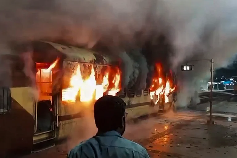 A coach of an empty passenger train catches fire at Katwa railway station, in Purba Bardhaman district, West Bengal. - | Photo: PTI