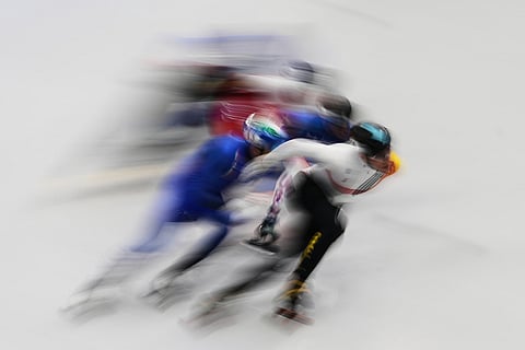 Stijn Desmet of Belgium leads the pack during in the men's 1500 meter short track speed skating at the 2026 Winter Olympics, in Milan, Italy.