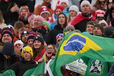 Brazilian fans cheer during the medal ceremony of an alpine ski, men's giant slalom race, won by Brazil's Lucas Pinheiro Braathen, at the 2026 Winter Olympics, in Bormio, Italy.