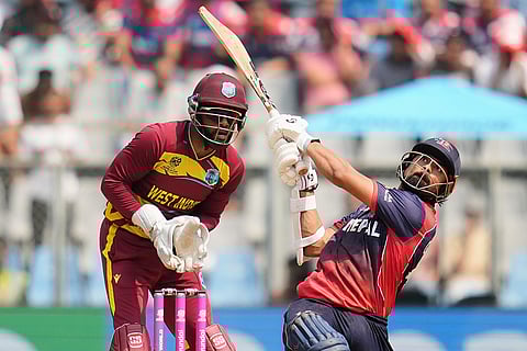 Nepal's Gulshan Jha hits a six during the T20 World Cup cricket match between Nepal and West Indies in Mumbai.