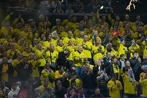 Swedish fans cheer during a preliminary round match of men's ice hockey between Sweden and Slovakia at the 2026 Winter Olympics, in Milan, Italy.